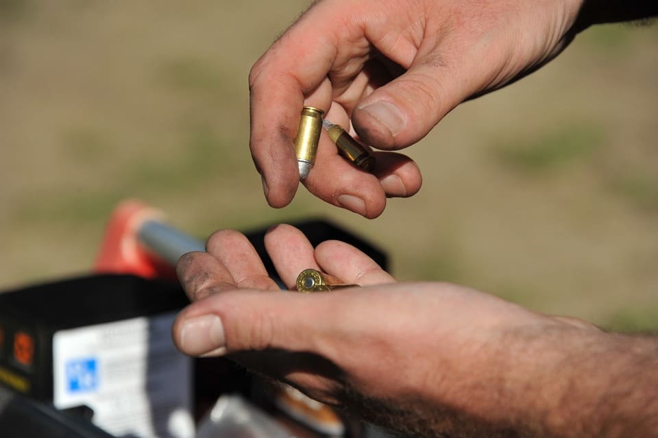 person-counting-bullets-in-their-hands