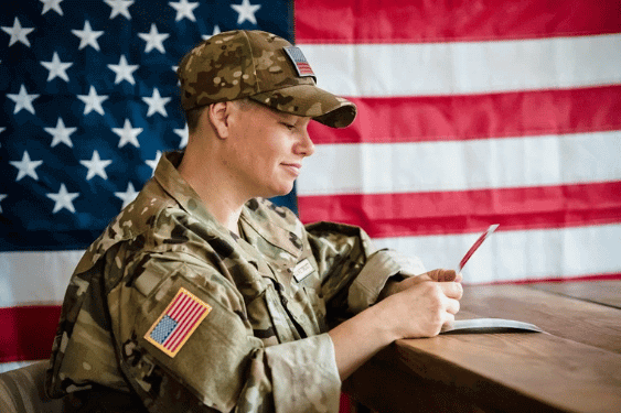 soldier-looking-at-a-picture-in-front-of-an-american-flag