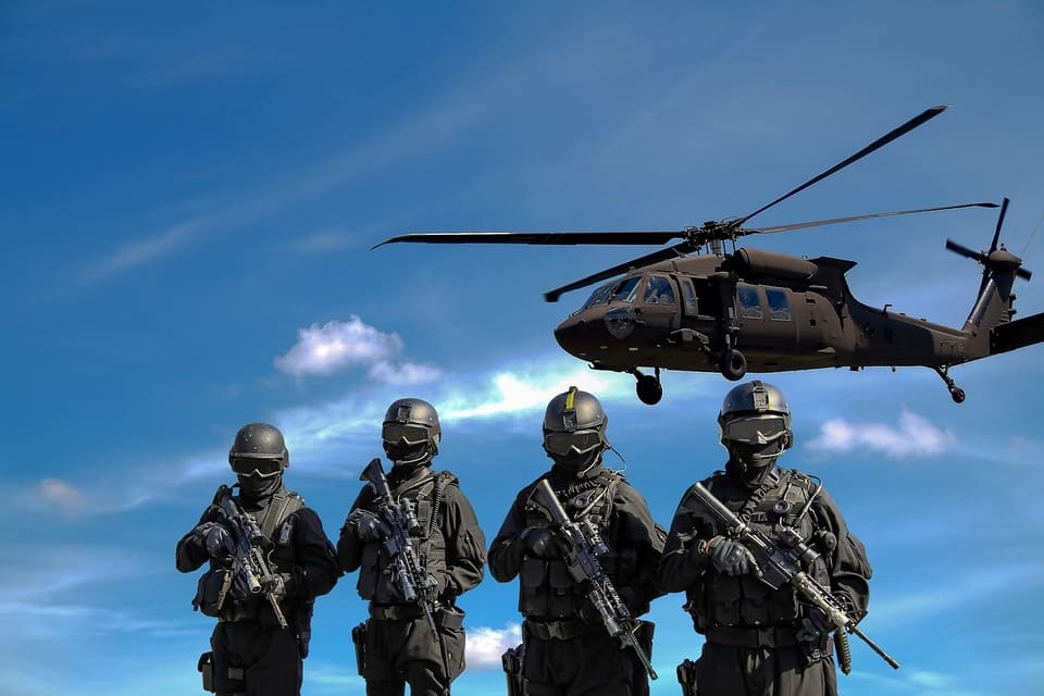 soldiers-standing-in-front-of-a-helicopter