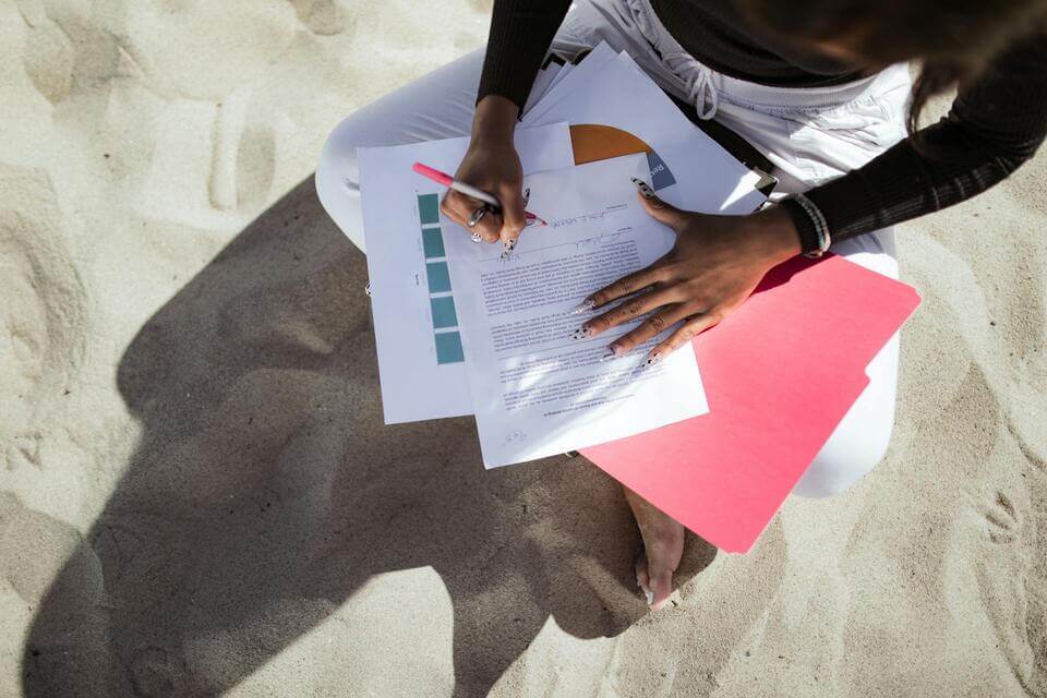 person-completing-forms-at-the-beach