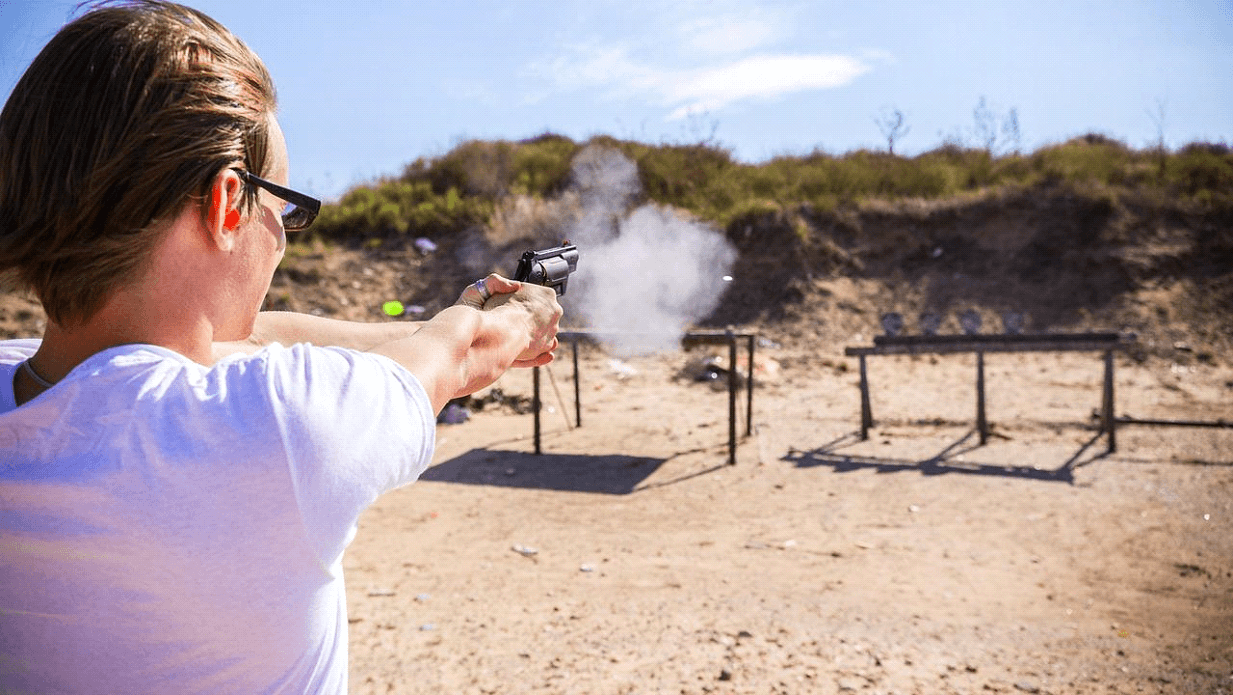 man firing pistol