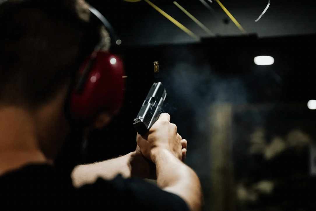 woman firing pistol in a gun range