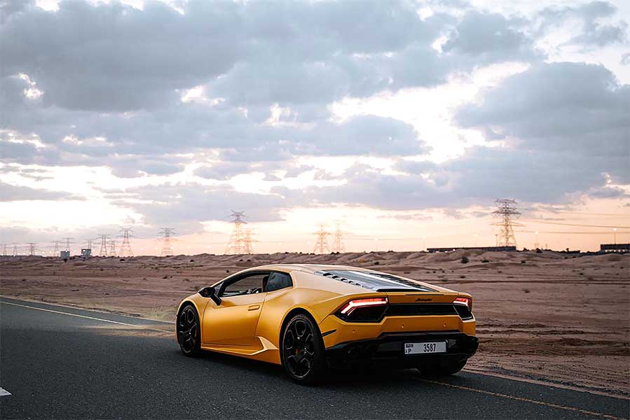 car-driving-past-a-desert-field