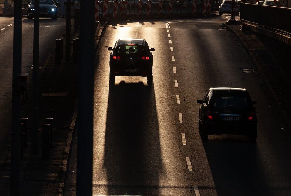 cars-driving-down-a-road-at-night